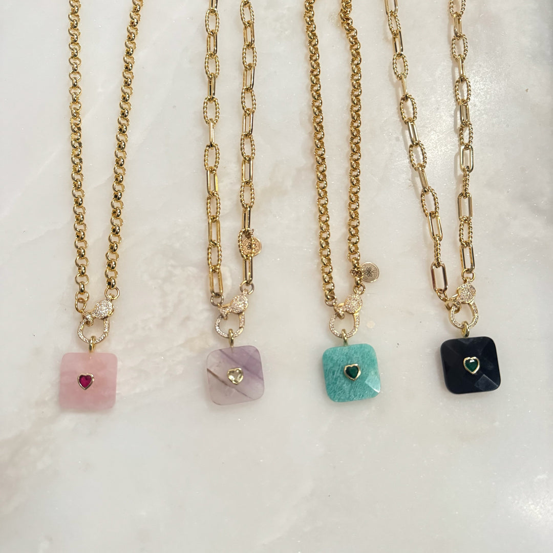 Mannaz Designs square gemstone pendant necklaces with heart inlays and pavé-encrusted gold-toned chains.